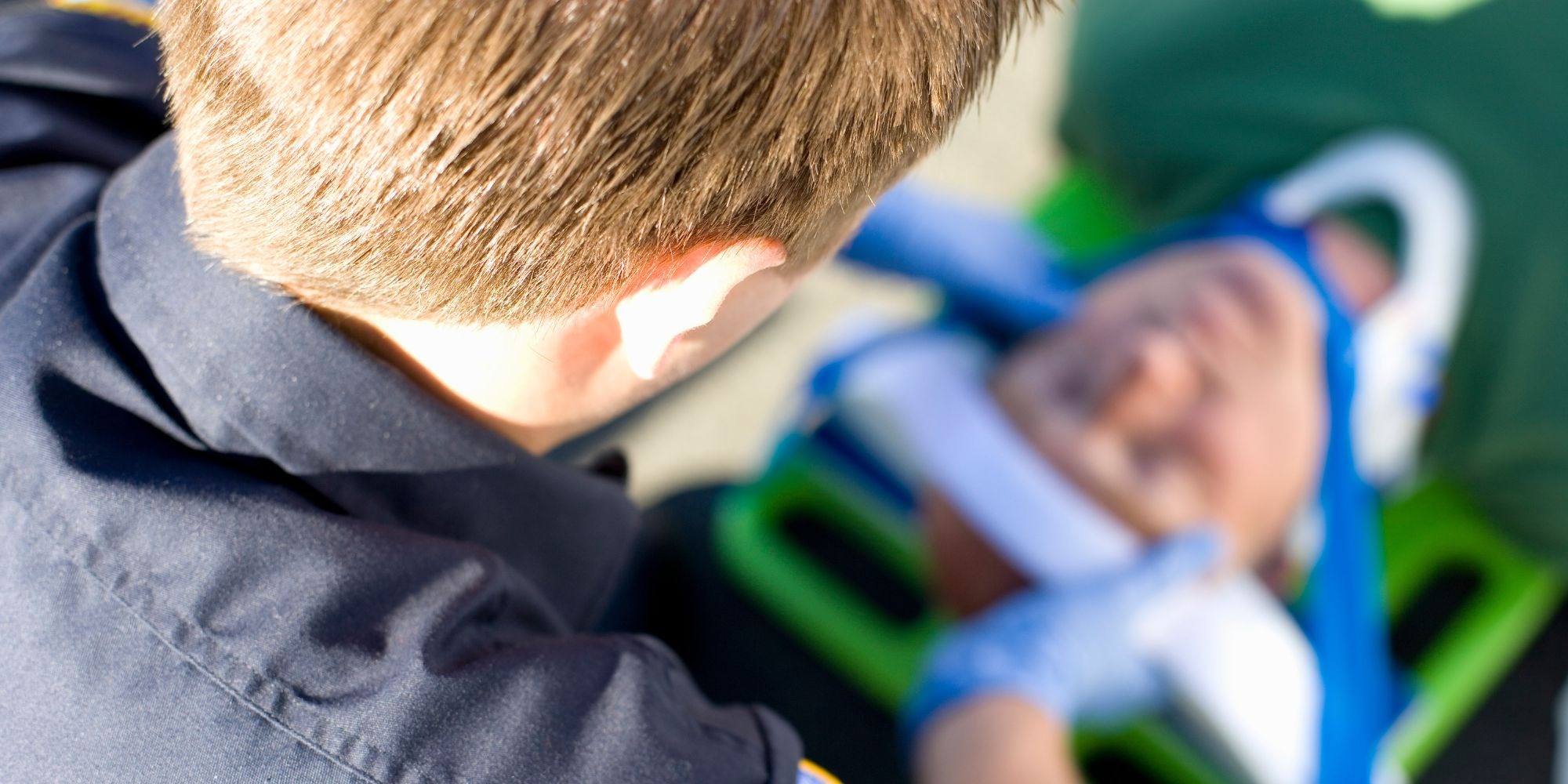 A close-up of responders attending to a patient on a stretcher