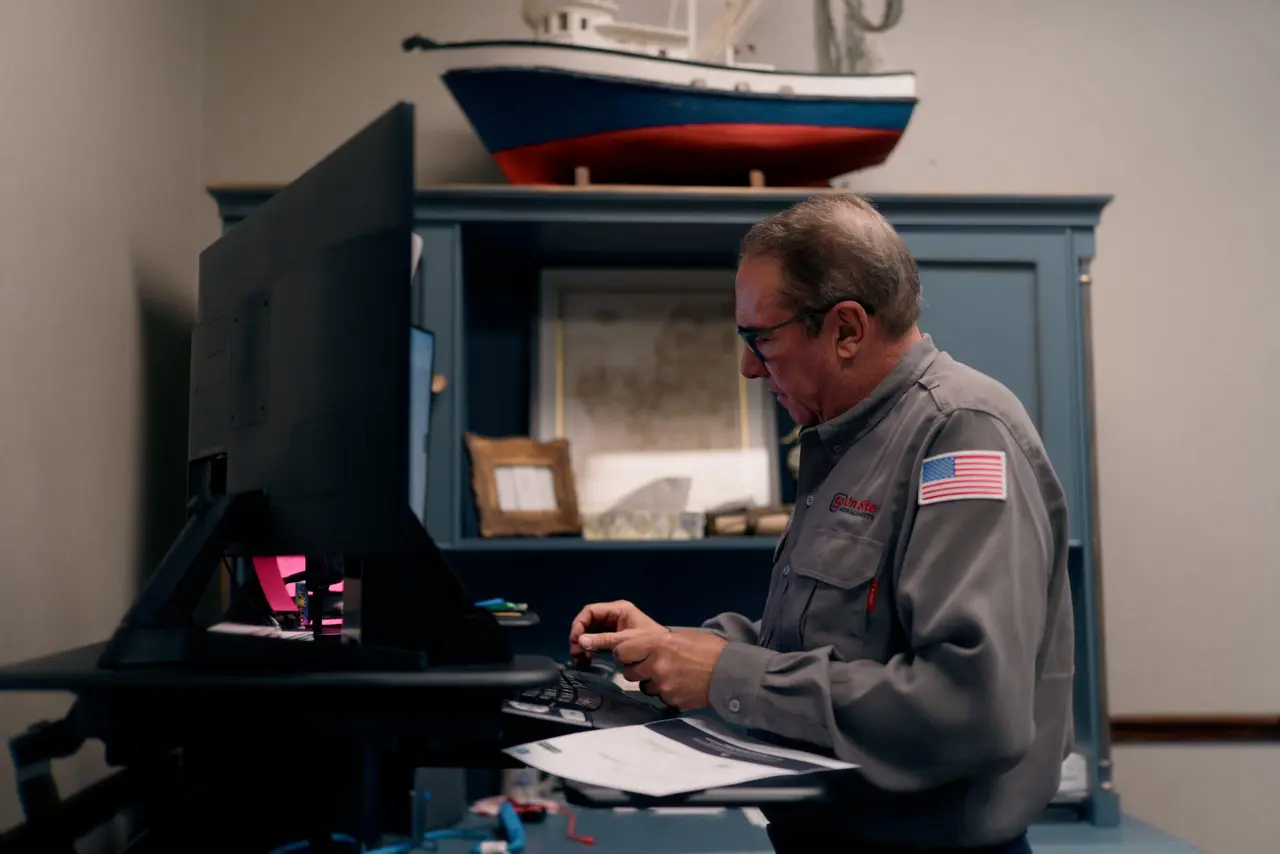 An On Site coordinator reviewing operations at a workstation