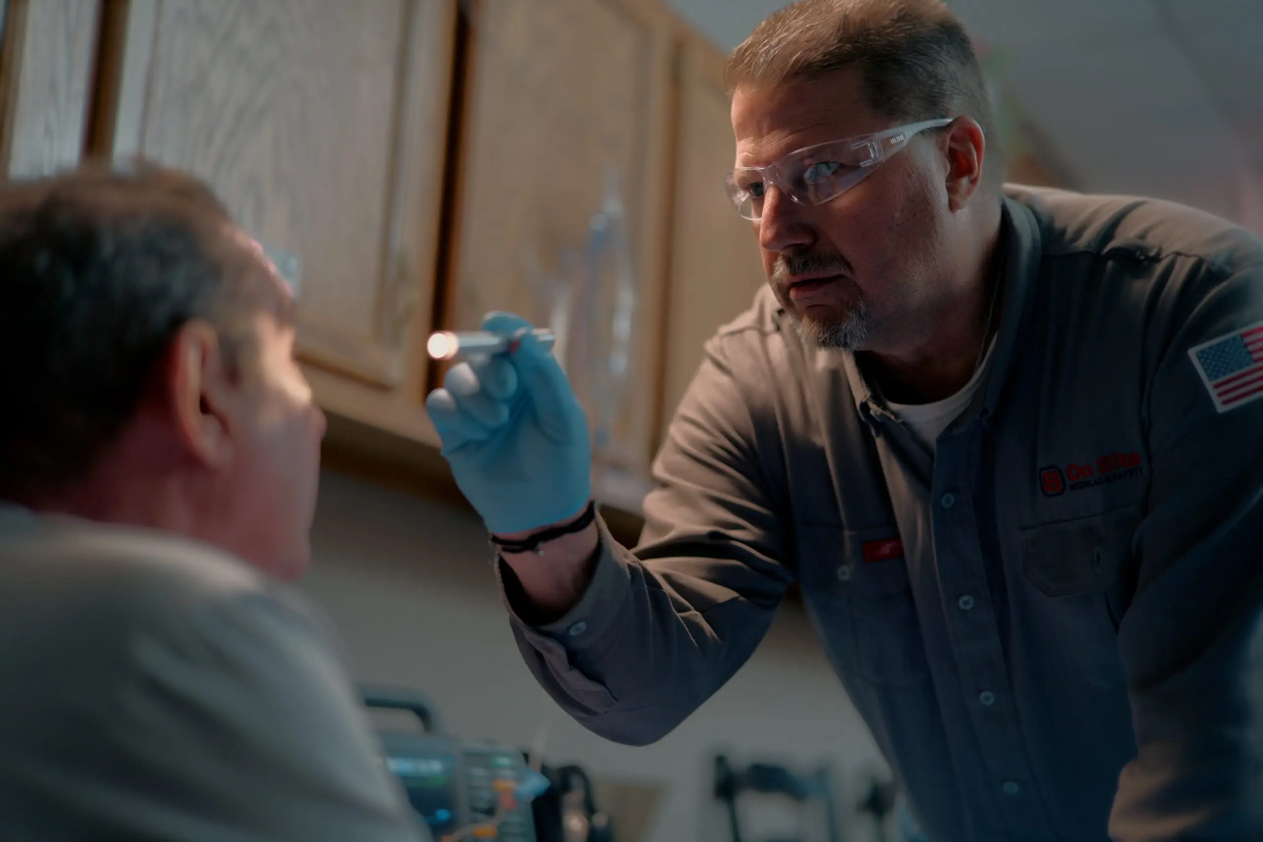 An On Site clinician performing a pen-light eye exam