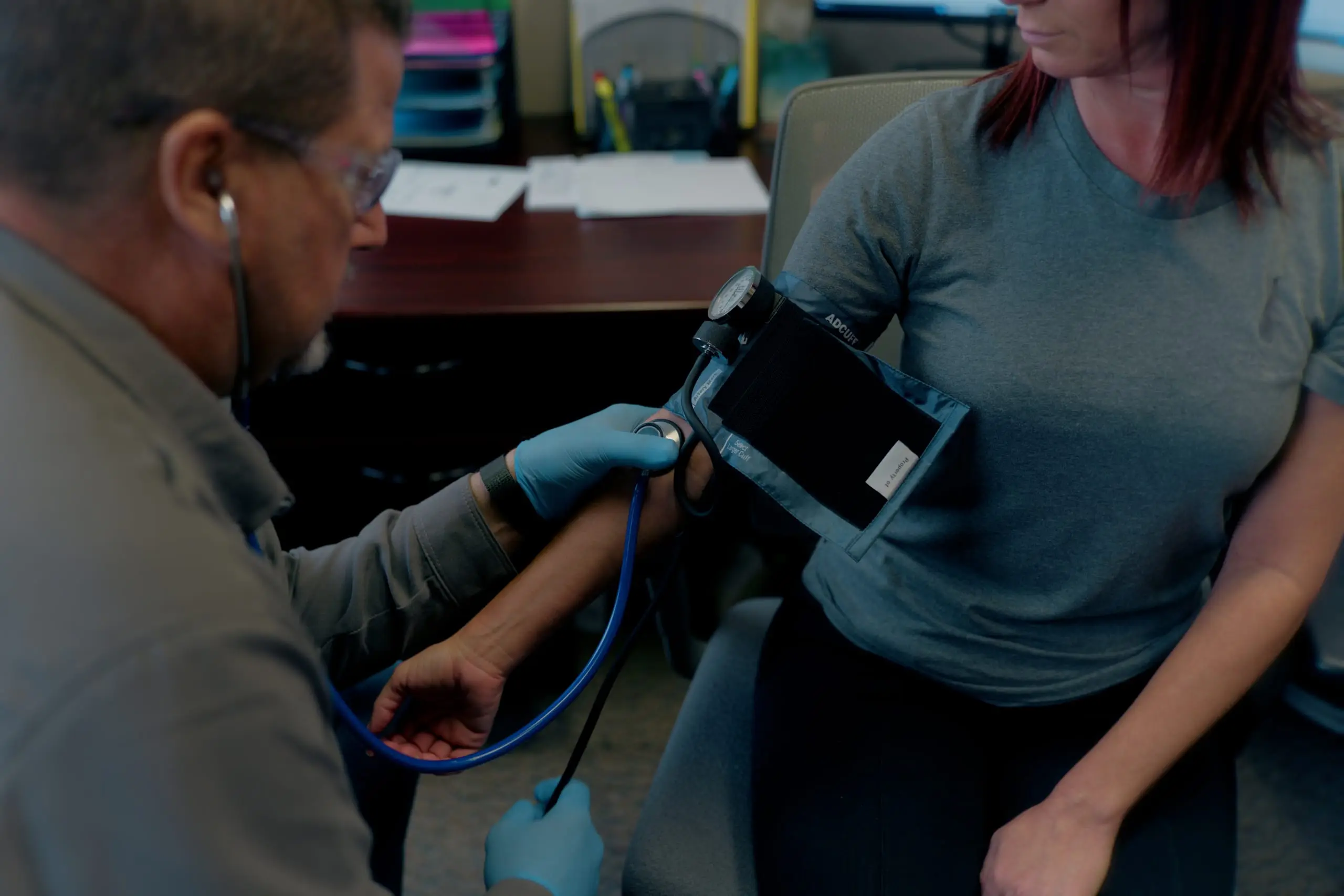 An On Site clinician performing a blood pressure check during a fitness-for-duty evaluation
