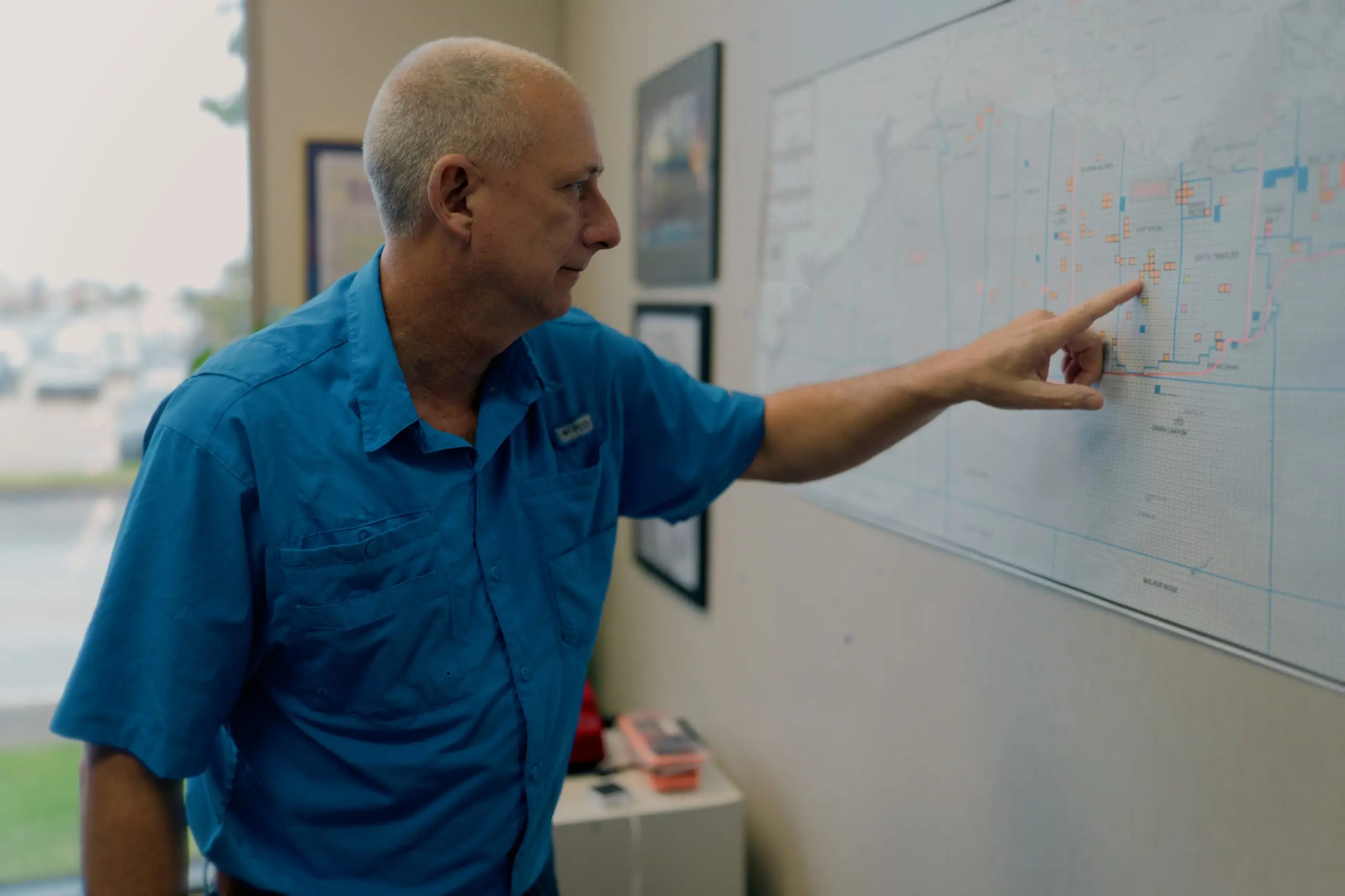 An On Site coordinator reviewing operations on a regional map
