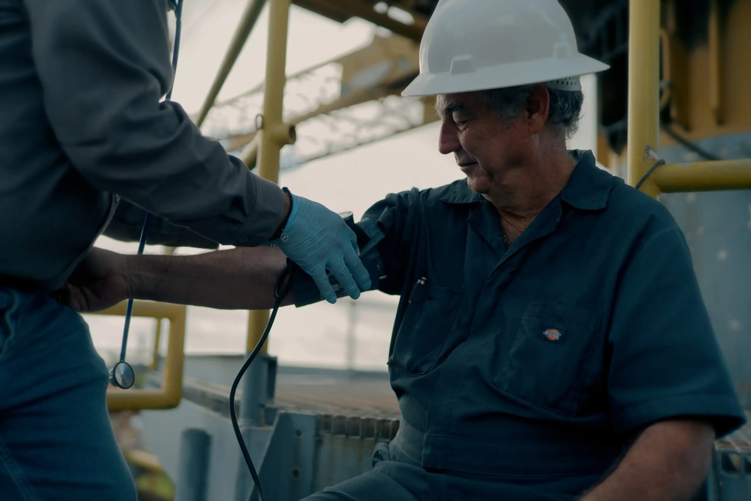 An On Site medic checking a worker's vitals on an offshore rig